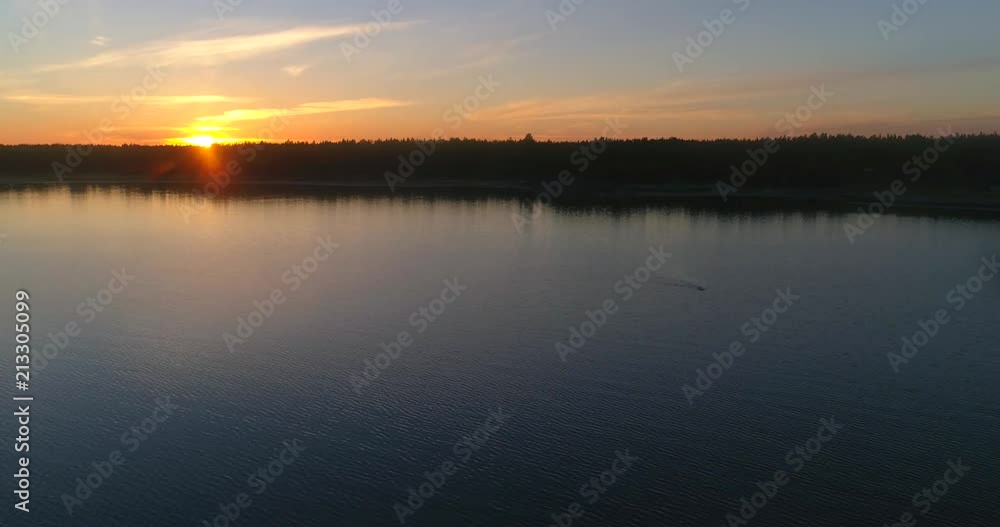 Man swimming at a calm sea, C4K aerial decreasing view of a diver at a clear and low waters of the gulf of finland, on a sunny summer evening dusk, in Hanko, Finland Man swimming at a calm sea, C4K aerial decreasing view of a diver at a clear and low waters of the gulf of finland, on a sunny summer evening dusk, in Hanko, Finland