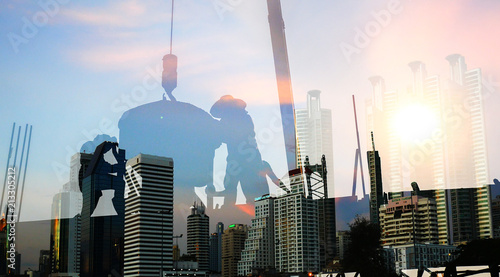 Double exposure of worker in construction site with city photo