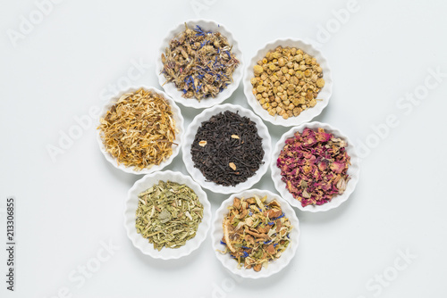 White bowls with different herbs for infusion.