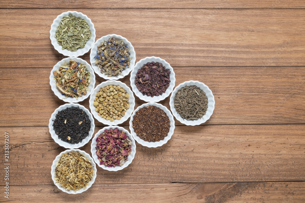 White bowls with different herbs for infusion. White bowls with different herbs for infusion.
