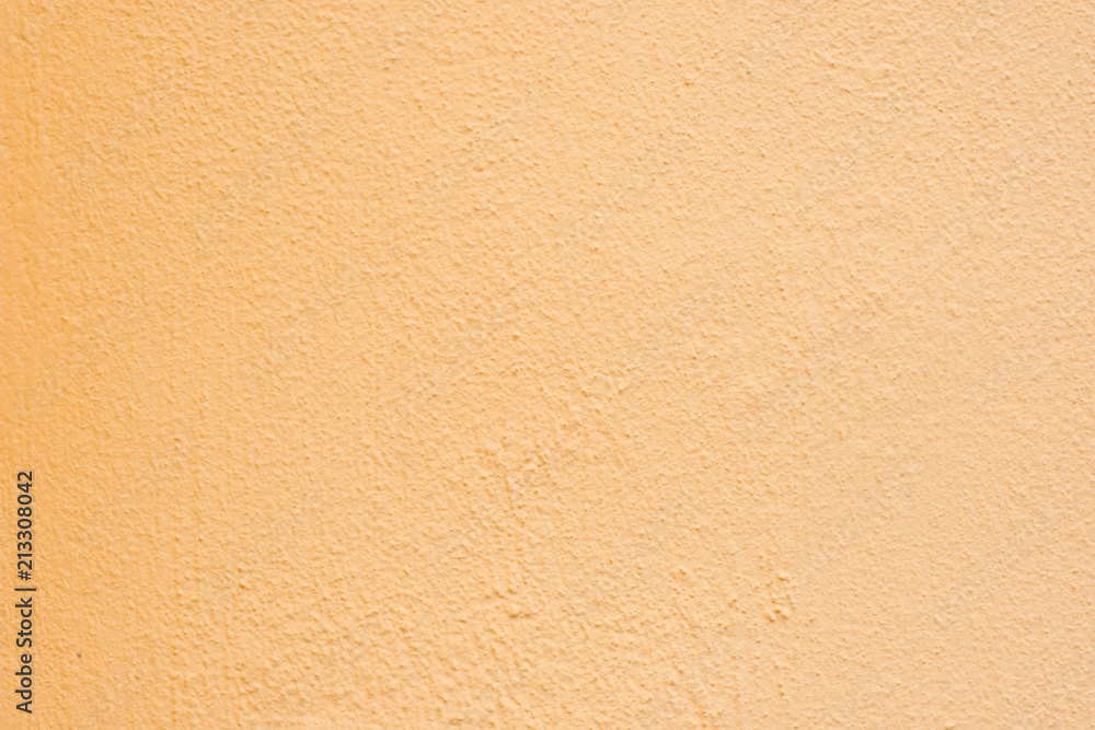 Background of a yellow stucco coated and painted exterior, rough cast of cement and concrete wall texture Background of a yellow stucco coated and painted exterior, rough cast of cement and concrete wall texture