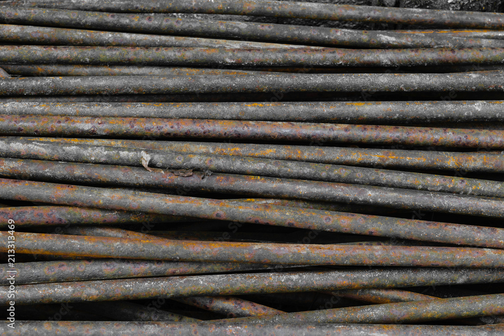 Old, rusty and brown metal rods background surface