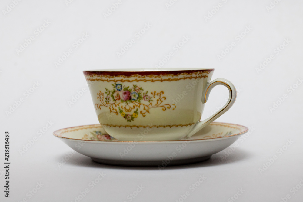 An isolated porcelain cup in a saucer An isolated porcelain cup in a saucer