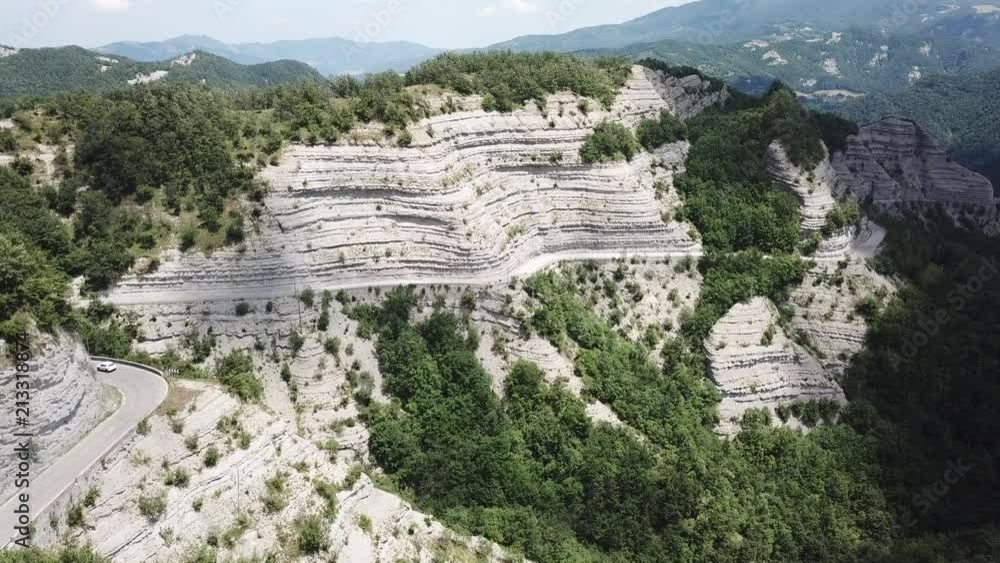 Italy. Scenic route to Mandrioli mountain pass. Landscape of walls made of sandstone and marl screeds named Scalacce. Tortuous curves Italy. Scenic route to Mandrioli mountain pass. Landscape of walls made of sandstone and marl screeds named Scalacce. Tortuous curves