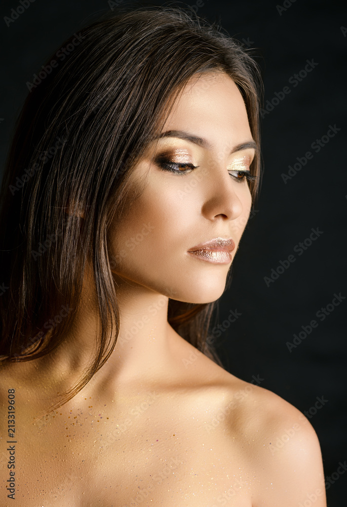 Close-up portrait of young woman with golden makeup. Close-up portrait of young woman with golden makeup.