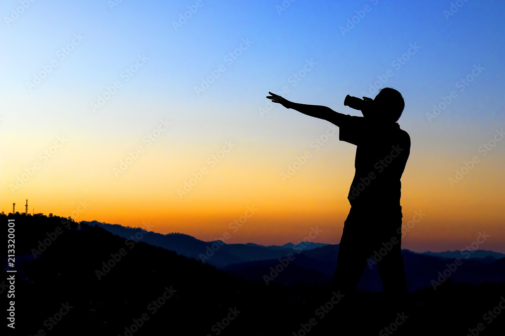 Silhouette of a photographer taking photo with sunset.