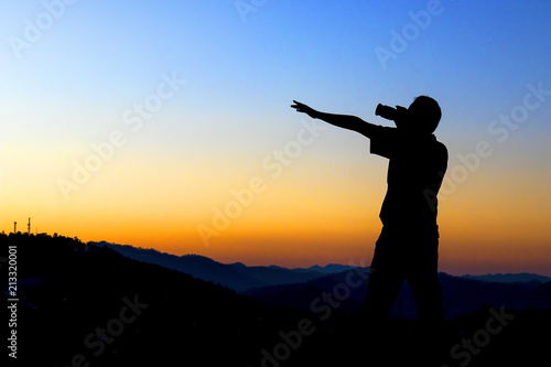 Silhouette of a photographer taking photo with sunset.