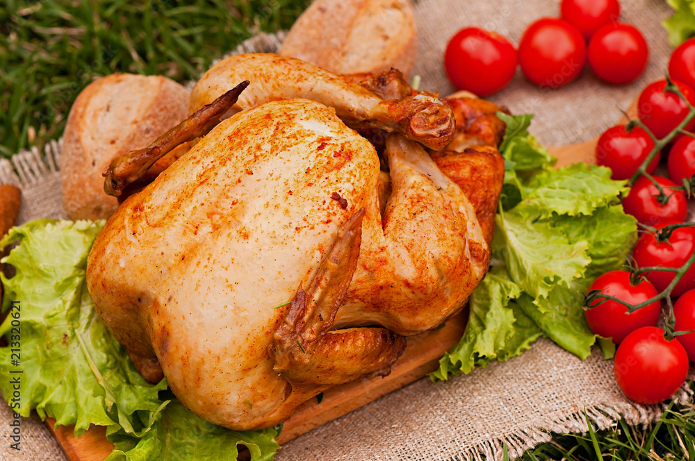 Baked chicken, on a green grass background. Natural food cooked on the grill. Baked chicken, on a green grass background. Natural food cooked on the grill.