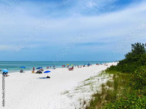 Fototapeta Naklejka Na Ścianę i Meble -  Tourists enjoying the Vanderbilt beach in Naples, Florida.