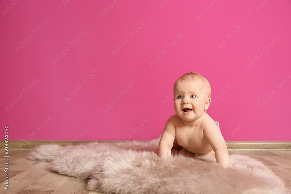 Cute little baby on fluffy rug near color wall Cute little baby on fluffy rug near color wall