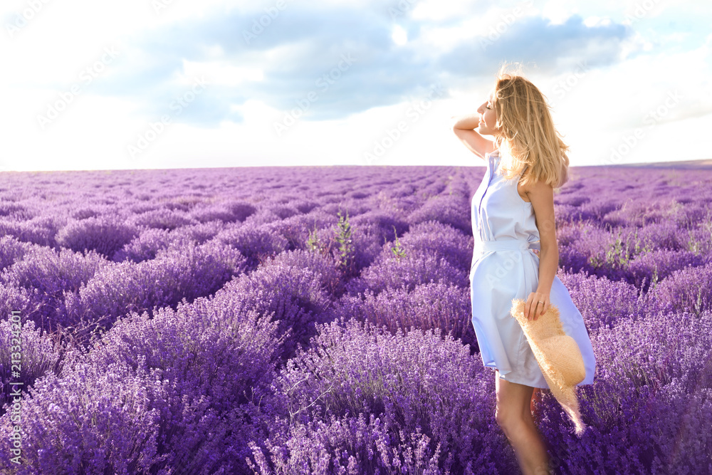 Young woman in lavender field on summer day Young woman in lavender field on summer day