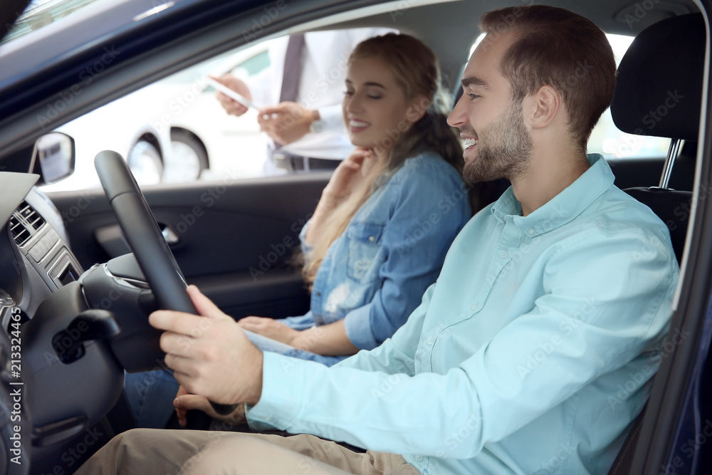 Young happy couple sitting in car Young happy couple sitting in car