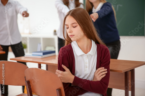Картината върху платно Teens bullying their classmate in school