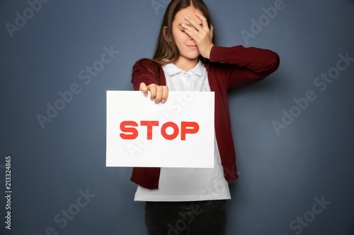 Teenage girl holding sign "...