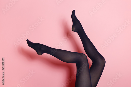 Legs of young caucasian woman in black tights photo