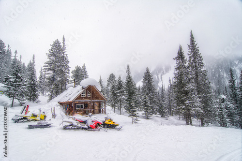Hut in the mountains of Lake Baikal during the snowfall © Burtasovsky