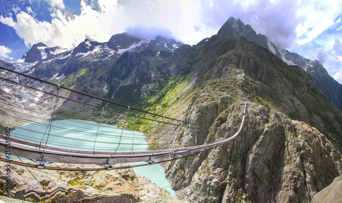 TRIFT HANGING BRIDGE. SWISS ALPS  NATURE. MOUNTAIN LANDCSAPE photo