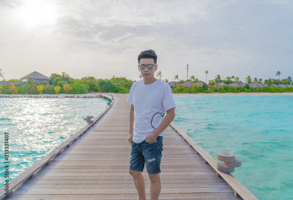 Asian smart man enjoyful traveling sea background. Asian smart man enjoyful traveling sea background.