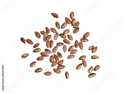 Some linseeds or flax seed spread out on white background seen from above