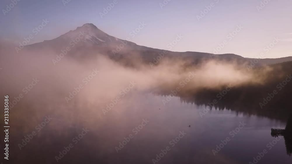 Aerial over misty mountain lake during sunrise Aerial over misty mountain lake during sunrise