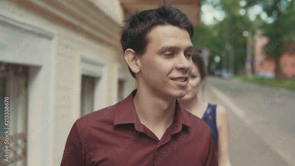 Sensitive kiss of loving couple in slow motion. Girl closes man's eyes with his hands for surprise Sensitive kiss of loving couple in slow motion. Girl closes man's eyes with his hands for surprise