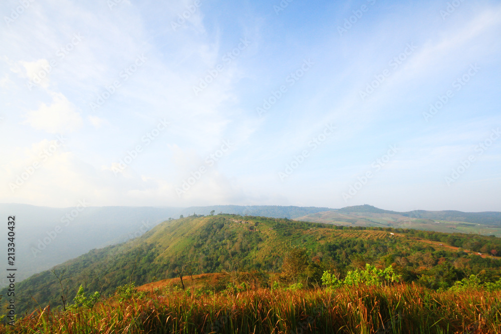Beautiful landscape and fog on the mountain and blue sky. Sunrise shining to the mist in forest of Thailand. Beautiful landscape and fog on the mountain and blue sky. Sunrise shining to the mist in forest of Thailand.