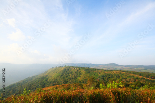 Beautiful landscape and fog on the mountain and blue sky. Sunrise shining to the mist in forest of Thailand.