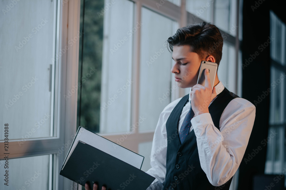 Businessman talking on phone with client, checking agenda.man speaking by phone. Businessman talking on phone with client, checking agenda.man speaking by phone.