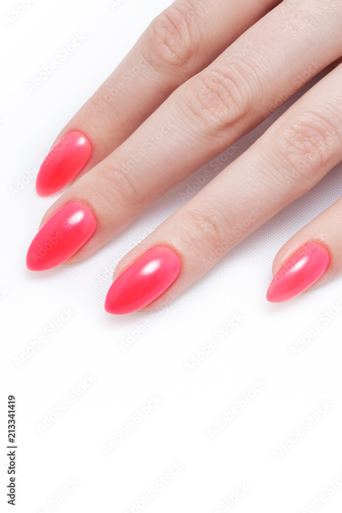 Women's manicure, on a white background. Nail Polish red coral color. Women's manicure, on a white background. Nail Polish red coral color.