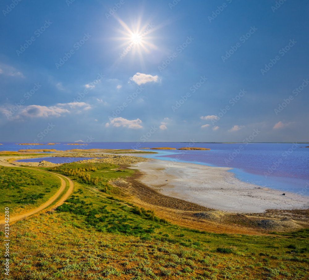 green hills, coast of saline lake under a hot summer sun