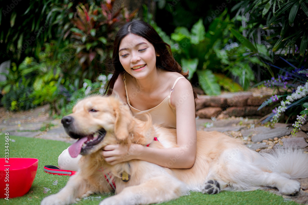 Beauty woman with her dog playing outdoors Beauty woman with her dog playing outdoors