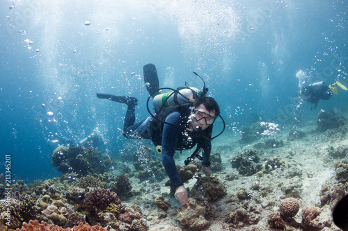 Underwater ocean scene with gas bubbles and divers. © frantisek hojdysz