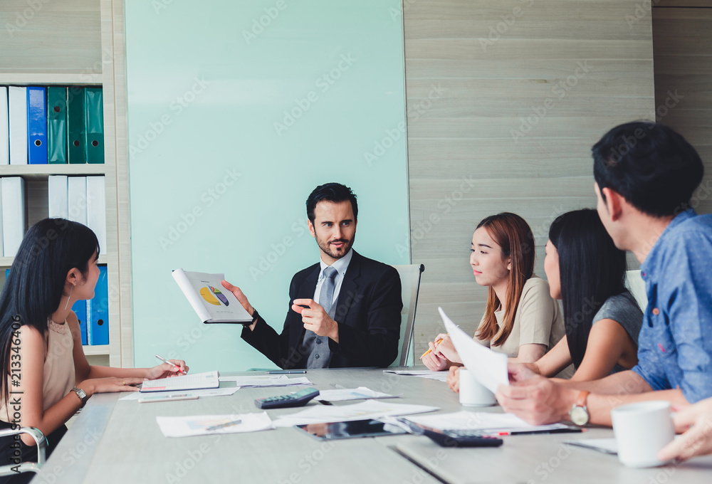 Manager holding papers hands and Smiling Professional team of coworlcers making great business discussion in modern office teamwork people. Manager holding papers hands and Smiling Professional team of coworlcers making great business discussion in modern office teamwork people.