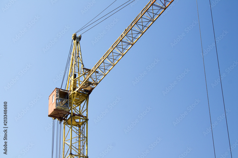 Photo of construction crane against a blue sky background