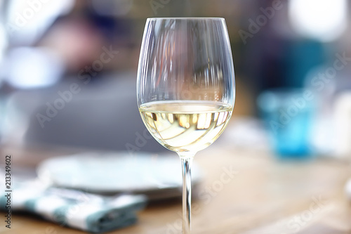 glass of white wine in the restaurant / white wine in the interior of the restaurant a table with glasses of wine, a romantic summer photo