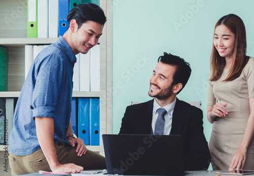 Group of business discussing ducuments and ideas at meeting.. photo