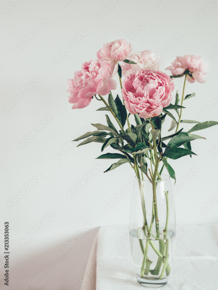 Fototapeta premium peony bouquet in vase on white table