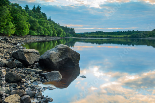 View of Fontburn Reservoir, Northumberland, England, UK, in evening light.