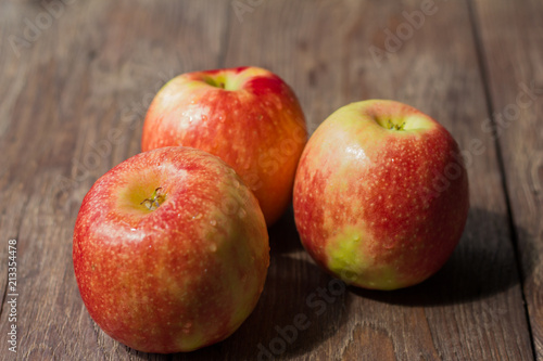 ripe red apples on wooden background