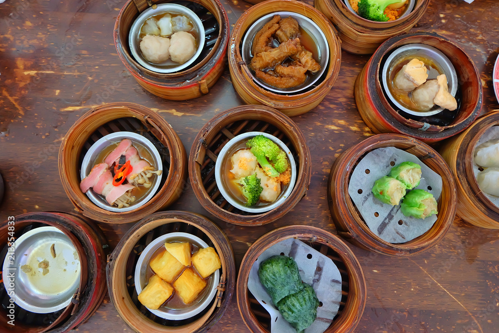 The Chinese food ,A many kind of Dim Sum in bamboo basket on table in chinese food restaurant. The Chinese food ,A many kind of Dim Sum in bamboo basket on table in chinese food restaurant.