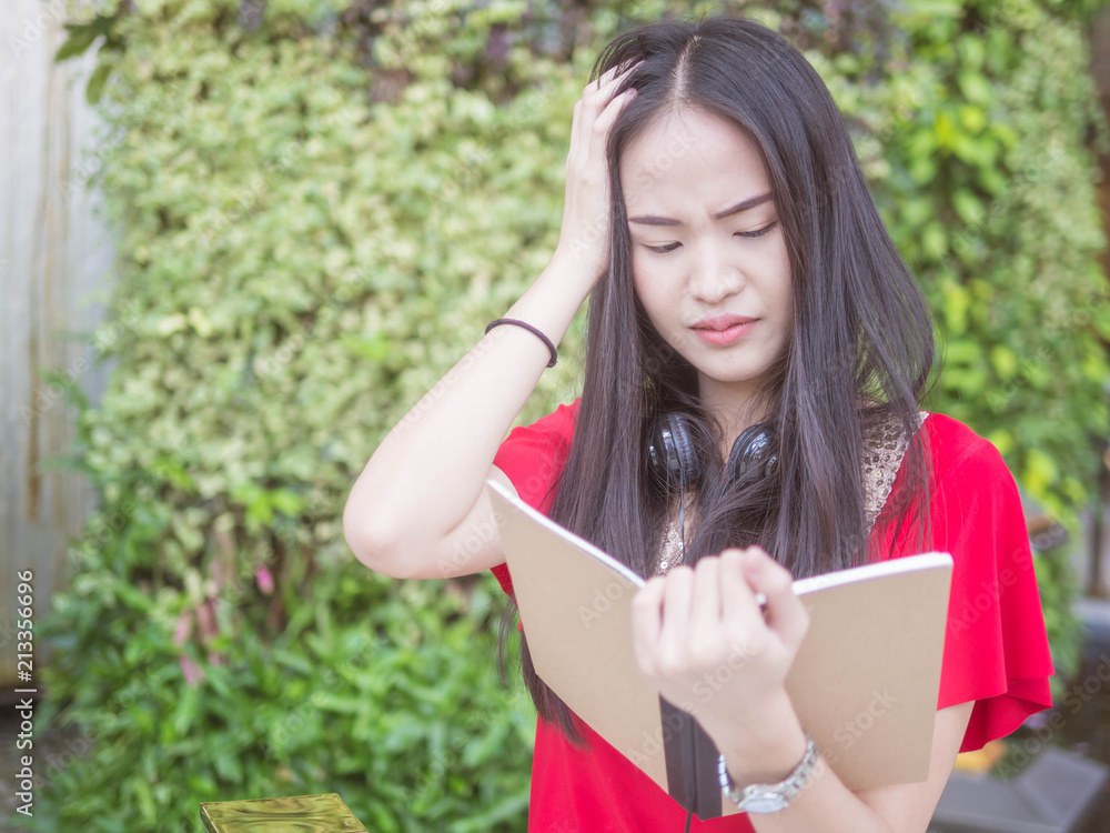 Young Asian female student with notebooks in her hands.A portrait of an Asian college student.education and learning concept. Young Asian female student with notebooks in her hands.A portrait of an Asian college student.education and learning concept.