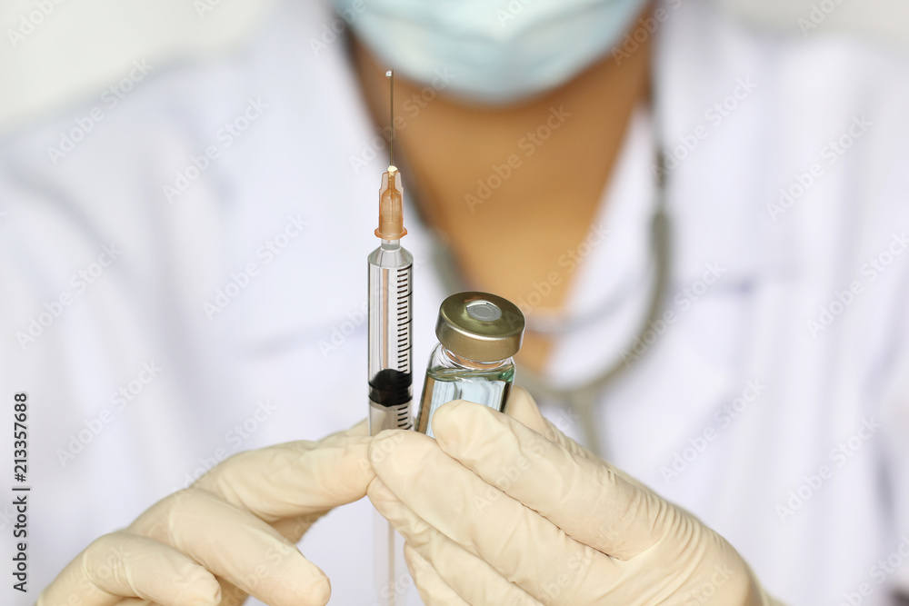 Doctor hand holding draw syringe and medicine bottle on white background, Medicine concept Doctor hand holding draw syringe and medicine bottle on white background, Medicine concept