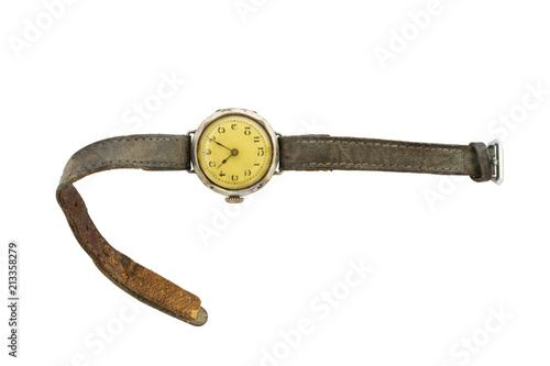 Closeup of a retro style yellow colored wristwatch with worn leather straps isolated on white background.