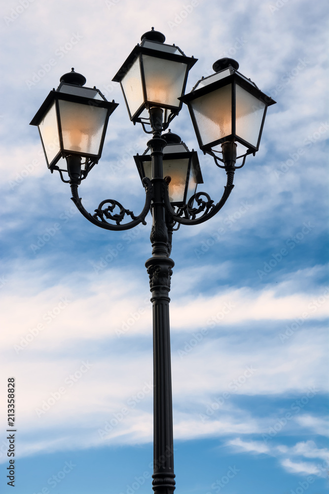 Street lamp lit at dusk