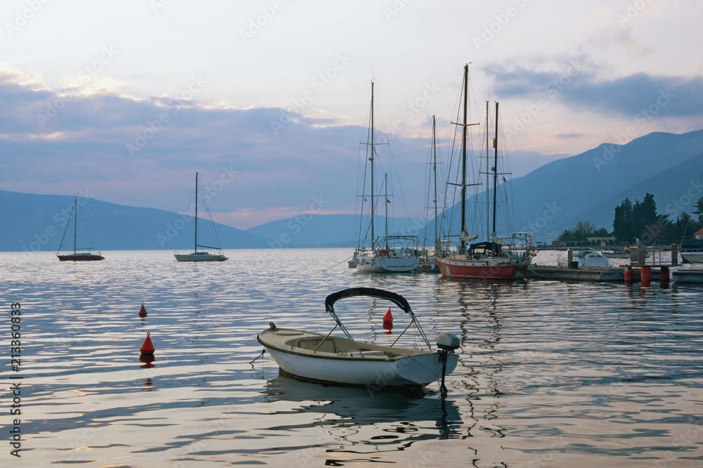 Evening Mediterranean landscape. Yachts and fishing boats on the water. Montenegro, Bay of Kotor (Adriatic Sea), Tivat