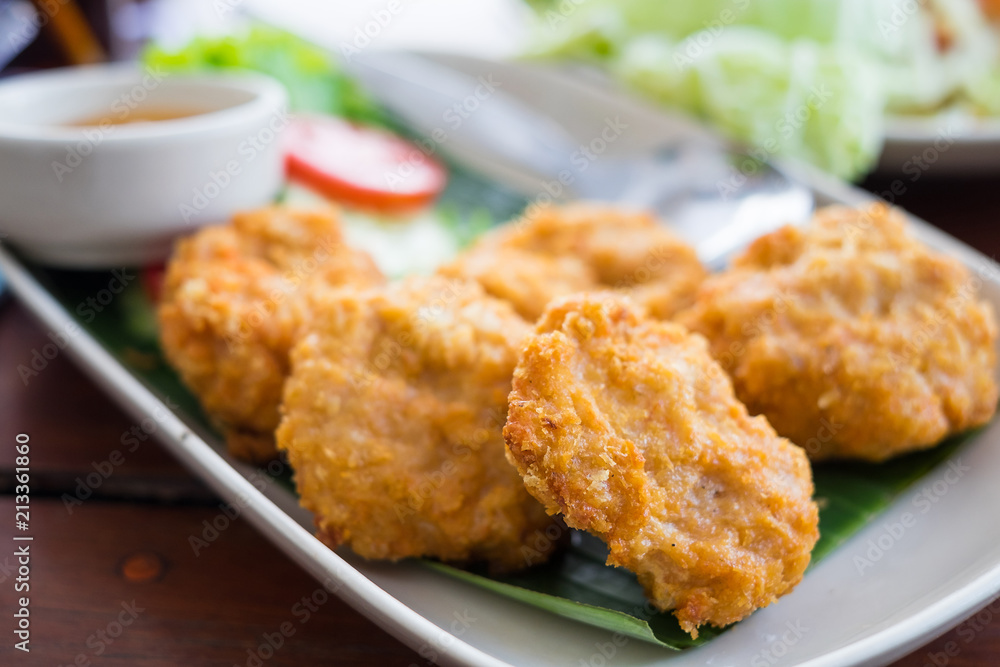 Thai Shrimps pancakes in white dish on wooden table background. Thai Shrimps pancakes in white dish on wooden table background.