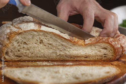 Man cutting bread