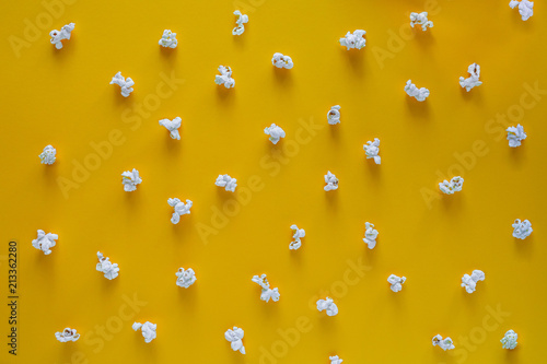 Popcorn pattern on yellow background. Top view. Contrast concept. popcorn on color background.