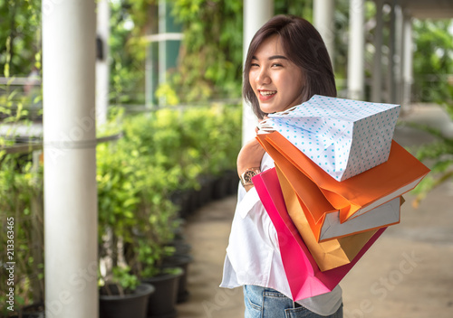 Foto Asian women shopping with multi color bag