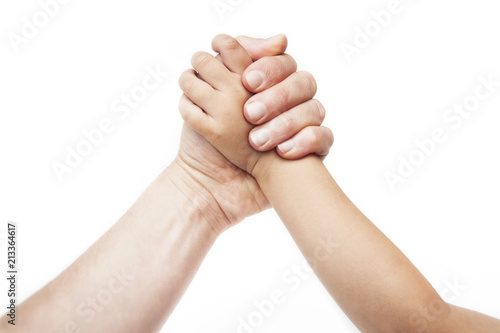 An adult's hand is measured by the hand of a small child on a white background. Concept of struggle of generations, misunderstanding between generations